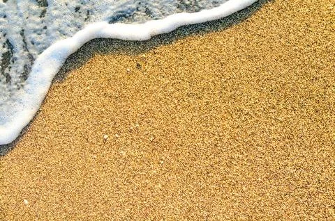 Summer Beach Background with Sea Waves and Sand. Travel and Vacation Concept. Stock Photos