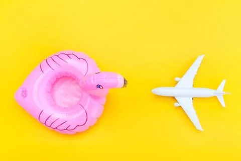 Summer beach composition. Minimal simple flat lay with plane and Inflatable f Stock Photos