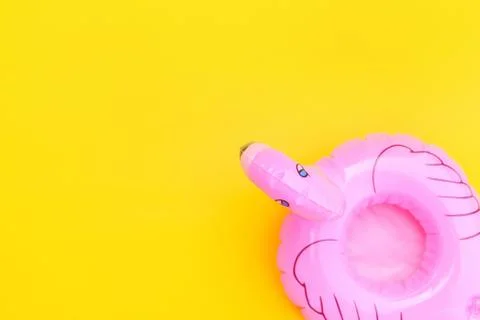 Summer beach composition. Simply minimal design with pink Inflatable flamingo Stock Photos
