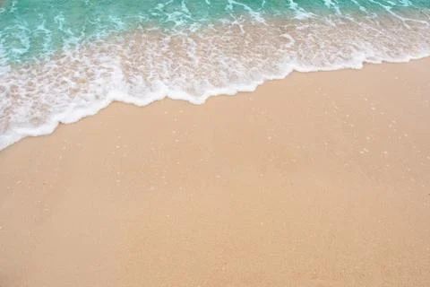 Summer beach concept - Soft wave of sea on empty sandy beach Background with  Stock Photos