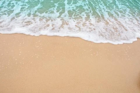 Summer beach concept - Soft wave of sea on empty sandy beach Background with  Stock Photos