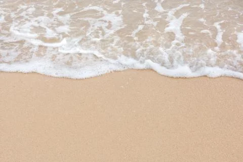 Summer beach concept - Soft wave of sea on empty sandy beach Background with  Stock Photos