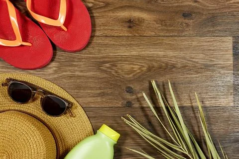 Summer Beach Essentials Featuring Flip-Flops, Straw Hat, and Sunglasses Stock Photos