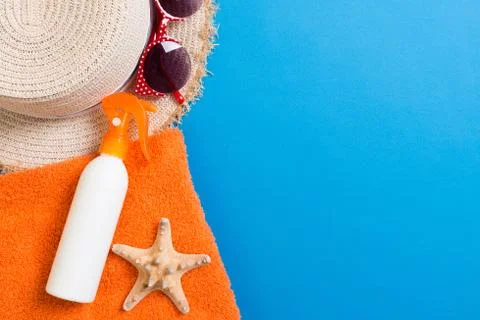 Summer beach flat lay accessories. Sunscreen bottle cream, towel and seashell Stock Photos