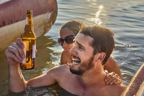 Summer beach fun drinking beer, running out Stock Photos