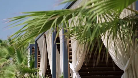 Summer beach gazebos with palm-fringed shores, ideal for resort hotels, tours, c Video stock 270084953