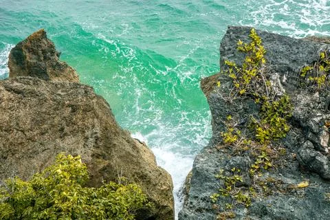 Summer Beach with Rocky Cliffs Overlooking the Ocean, Soft Waves Gently Rol.. Stock Photos