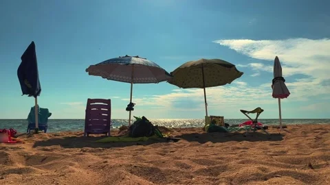 Summer beach scene with sun umbrellas and chairs Видео 277516420