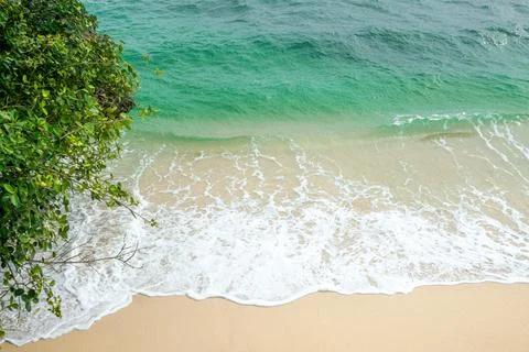 Summer Beach with Soft Waves Gently Rolling Toward the Shore, Creating a Tr.. Stock Photos