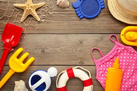 Summer beach toys with accessories on grey background with copy space. Summer Stock Photos
