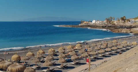 Summer beach with umbrellas and turquoise ocean water from. Beach on a Sunny day Stock Footage 124281898