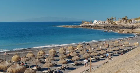 Summer beach with umbrellas and turquoise ocean water from. Beach on a Sunny day Stock Footage 124559848