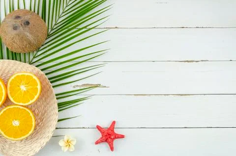 Summer beach vacation background, oranges, coconut, palm leafs and starfish top Stock Photos