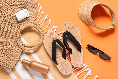 Summer beach vacation essentials flat lay with straw bag, flip-flops, sun vis Stock Photos