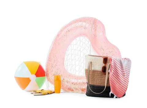 Summer beach vacation essentials with inflatable ring, beach ball, sunscreen, Stock Photos