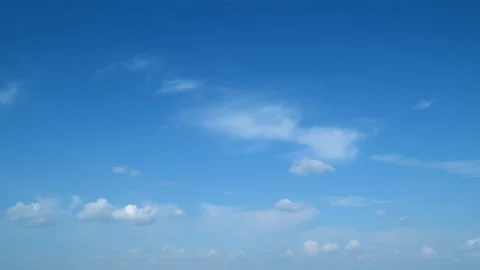 Summer blue sky with fluffy white clouds. White clouds float across the blue sky Stock Footage 217376733