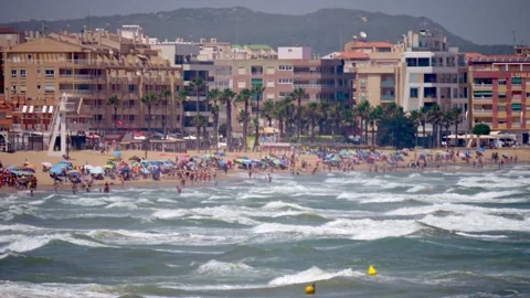 The summer buzz is tangible on this crowded beach with its spectrum of para.. Vidéo 248952991