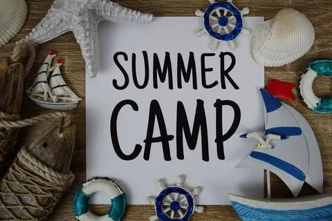 Summer Camp text on paper card with marine items decorative top view on woo.. Stock Photos