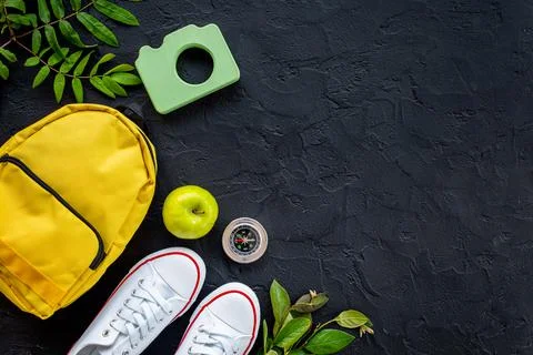 Summer camping concept flatlay with a backpack and sneakers Stock Photos