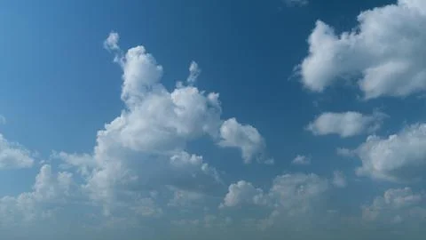 Summer clouds float across blue sky. Blue sky white clouds. Timelapse. 스톡 사진