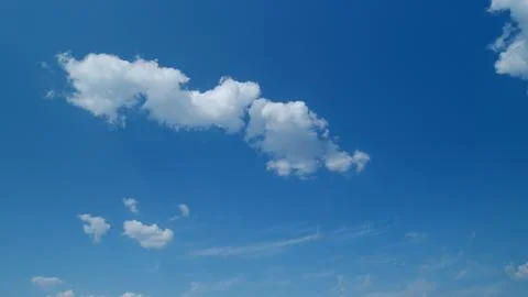 Summer clouds float across blue sky. Blue sky white clouds. Timelapse. 스톡 사진