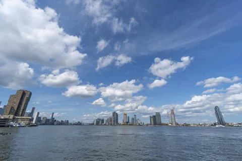Summer clouds float over the East River and Long Island City NYC. 스톡 사진