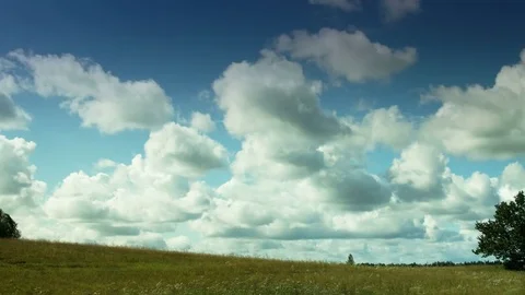 Summer clouds move through natural landscape – pan Stock Footage 83021662