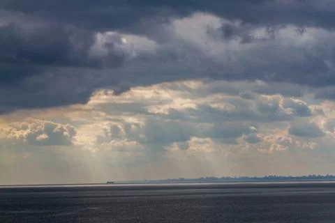 Summer cloudy sky over the sea Stock Photos