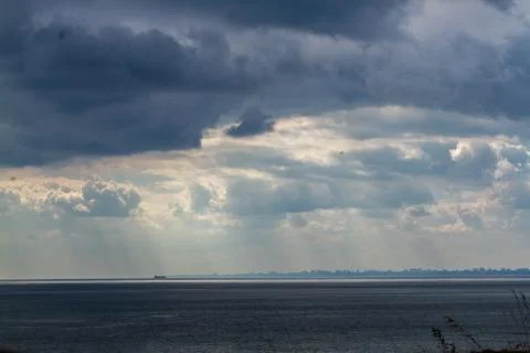 Summer cloudy sky over the sea Stock Photos
