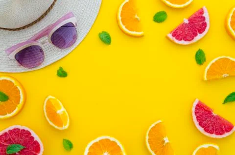 Summer composition arranged in a frame of sliced citrus fruits with little mint Stock Photos