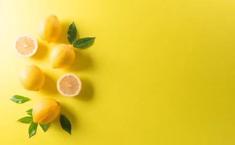 Summer composition made from oranges, lemon or lime on pastel yellow backgrou Stock Photos