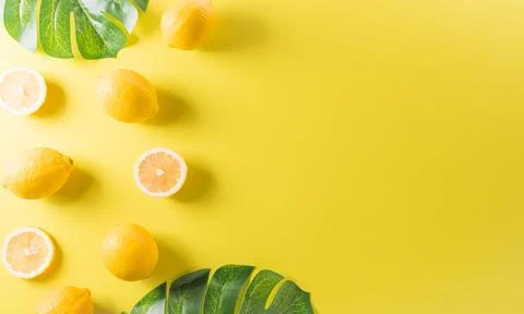 Summer composition made from oranges, lemon or lime on pastel yellow backgr.. Stock Photos