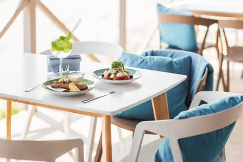 Summer composition on the summer playground table and chairs . tasty meats of Stock Photos