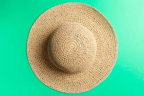 Summer concept. Braided hat on Mint background. Top view. Neo Mint color of t Stock Photos