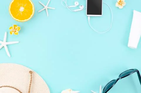 Summer concept flat lay frame with orange, hat, sunglasses and smartphone on Stock Photos