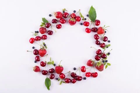 Summer concept. Flat lay, top view, copy space.  Frame made of fresh berries. Stock Photos