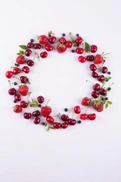 Summer concept. Flat lay, top view, copy space.  Frame made of fresh berries. Stock Photos