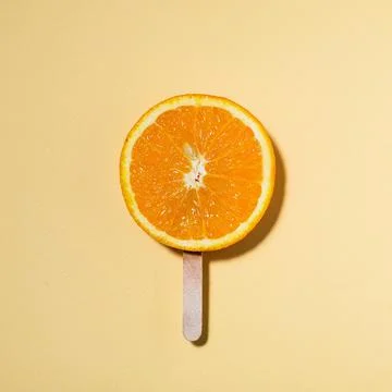 Summer concept orange on a stick instead of ice cream - Piece of juicy orange Stock Photos