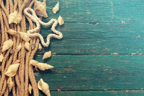 Summer concept with sandy beach, shells and cord. Stock Photos