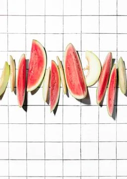 Summer concept with sliced melon and watermelon pieces put in a raw Stock Photos