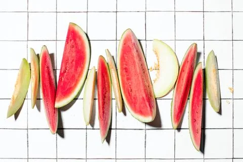 Summer concept with sliced melon and watermelon pieces put in a raw Stock Photos