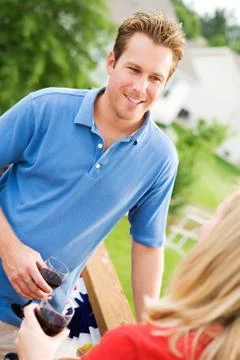 Summer: couple standing on deck with wine Stock Photos