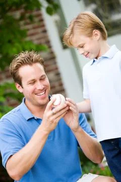 Summer: dad teaches boy about pitching Stock Photos
