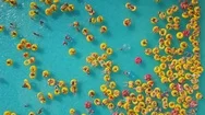Summer Day City Waterpark Crowded Yellow Rings Pool Aerial View Panorama 4K Stock Footage