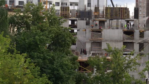 Summer day at construction site with crane lifting concrete slabs. Stock Footage 330396589