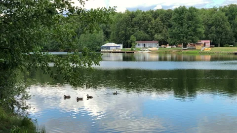 Summer day at lake with clouds reflect on rippling water Stock Footage 161031671