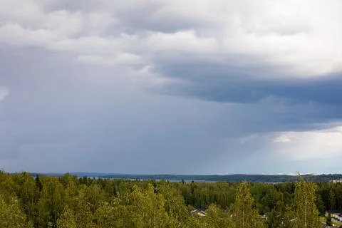 Summer day raining viewed from far Stock Photos