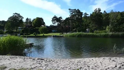Summer day at a river beach in Norway with green landscape and cabins on th.. Stock Footage 340202641