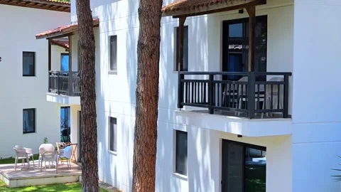 Summer day, view on bright sun and houses. Cottage settlement on sea coastline. Video stock 313614450