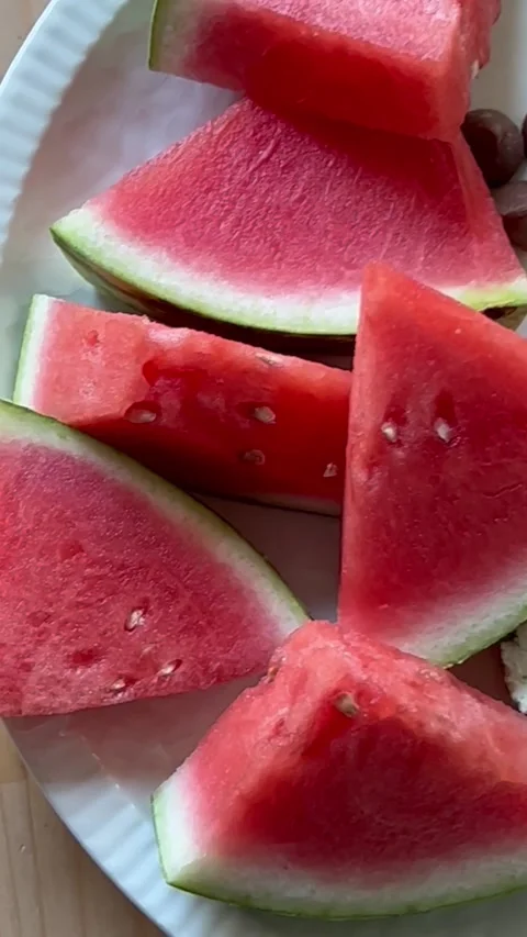 Summer dinner of cheese, crackers and watermelon vertical Stock Footage 247663677